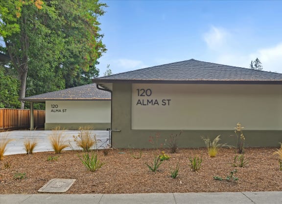 A small building with a sign that says 120 Alma St.
