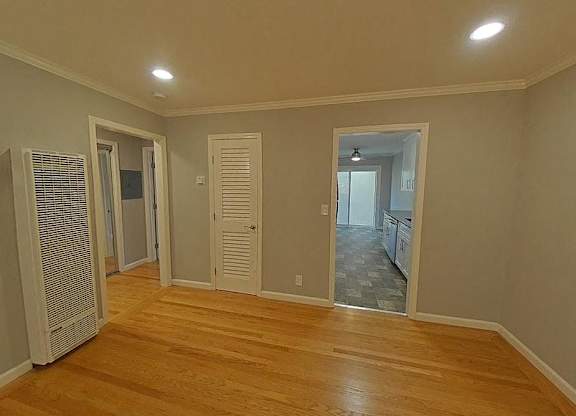 A room with wooden floors and white walls.