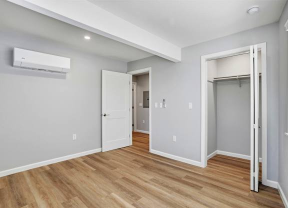 A room with a wooden floor and a white door.