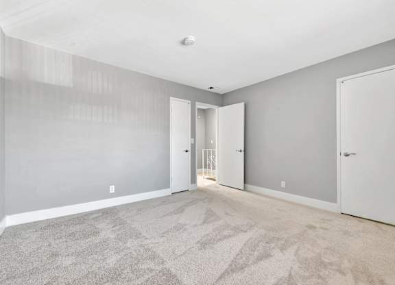 A room with grey walls and a carpeted floor.