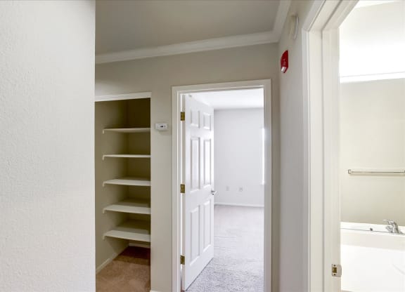 A white door is open to a bathroom.