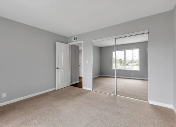 Bedroom with large closet and mirrored doors