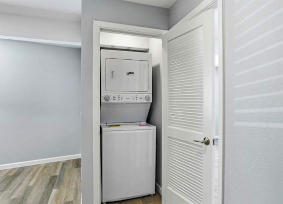 A white oven and dishwasher are built into a wall in a kitchen.