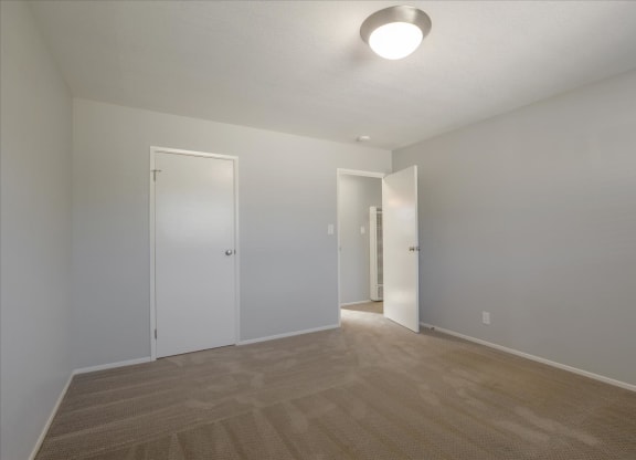 a living room with a hard wood floor and white walls