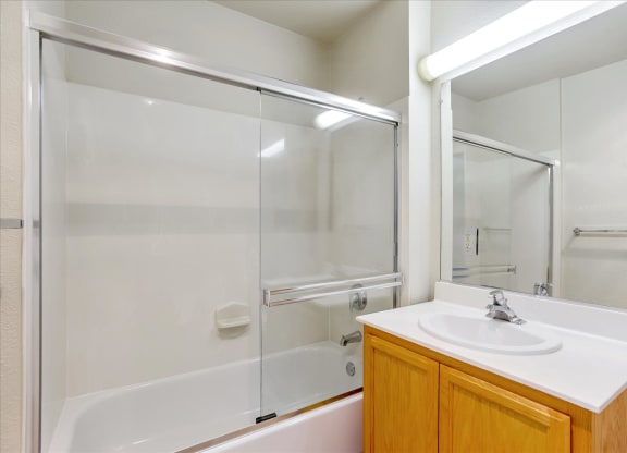A white sink is on a counter in a bathroom.