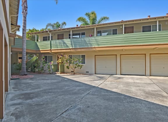 the driveway is in front of a building with garage doors