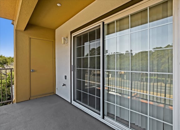 A yellow door is on the left of a glass window.