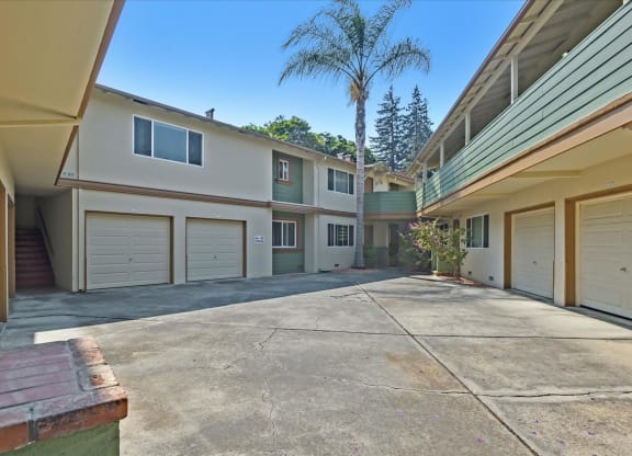 the driveway is in front of a row of garage doors