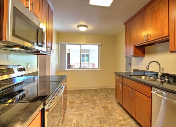 A kitchen with wooden cabinets and stainless steel appliances.