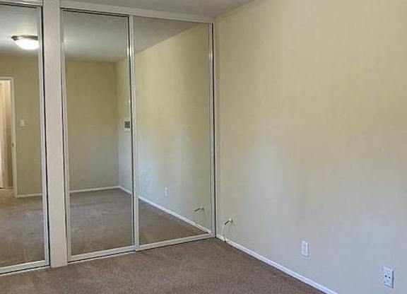 an empty room with a large mirror in it
