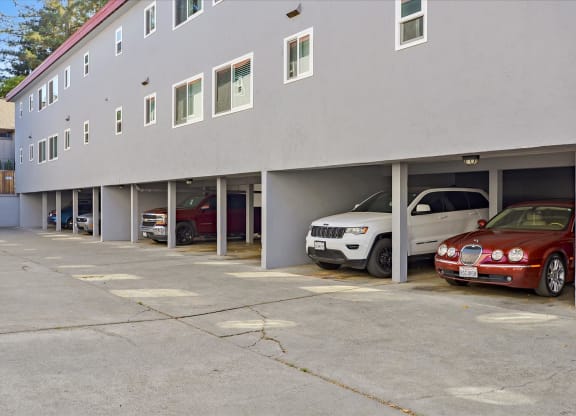 a parking lot with cars parked in front of a building