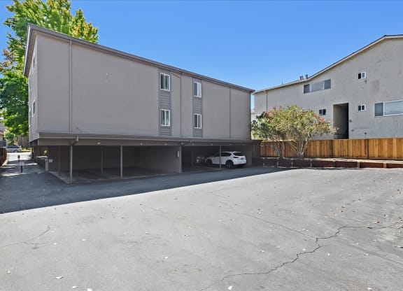 an empty parking lot between two buildings