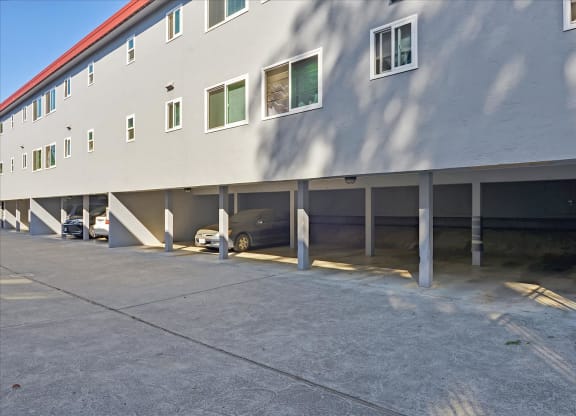 a parking lot with cars parked in front of a building