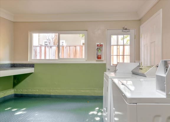 a kitchen with a washer and dryer and a window