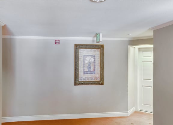 A picture frame with a painting hanging on a wall.