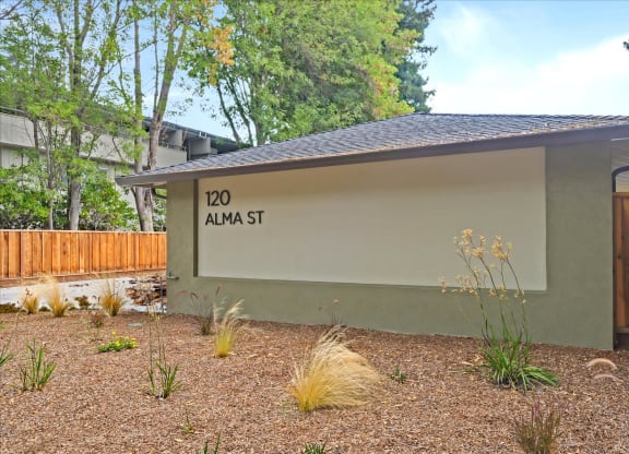 A building with a sign that says 120 Alma St.