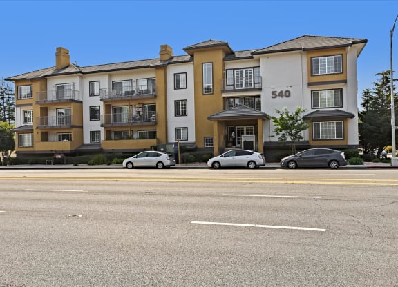 Apartment building number 540 with cars parked in front.