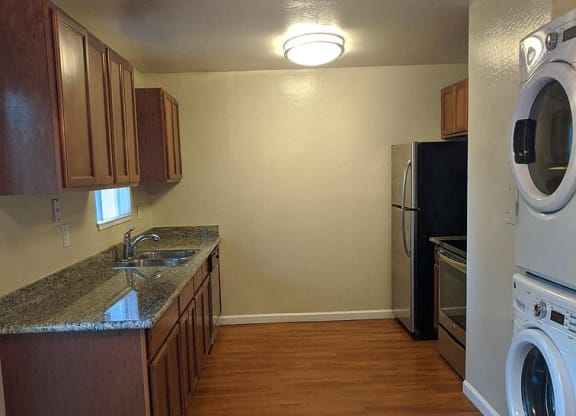 a kitchen with a washing machine and a dryer in it