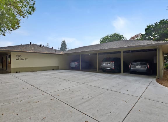 A house with a garage that has two cars parked in it.