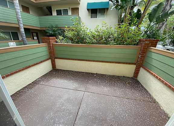 a balcony with a green bench on top of it