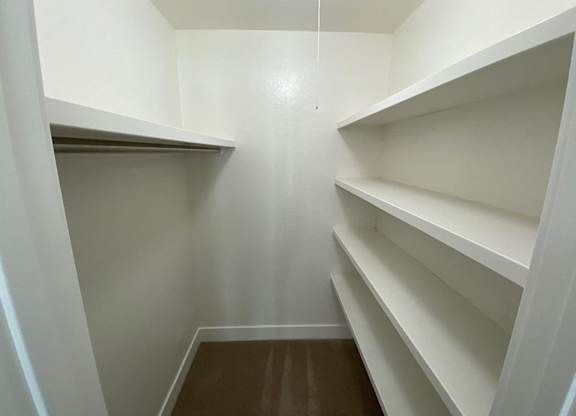 Empty white shelves in a room.