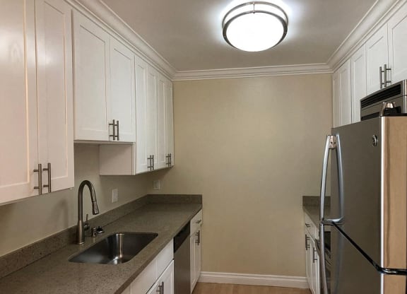 a kitchen with a sink and a refrigerator