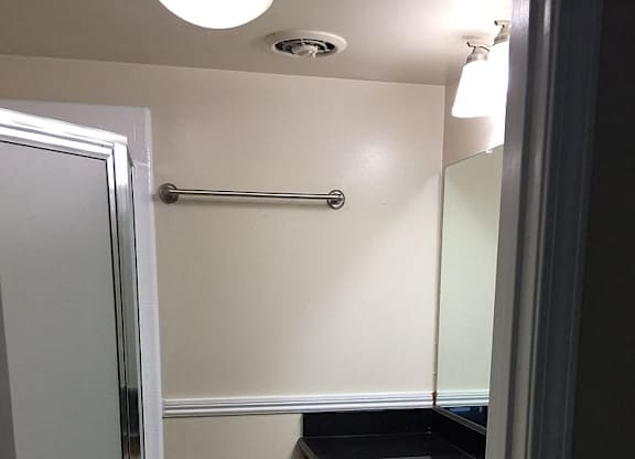 A bathroom with a sink and mirror.