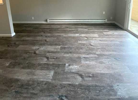 A room with a grey floor and a window.