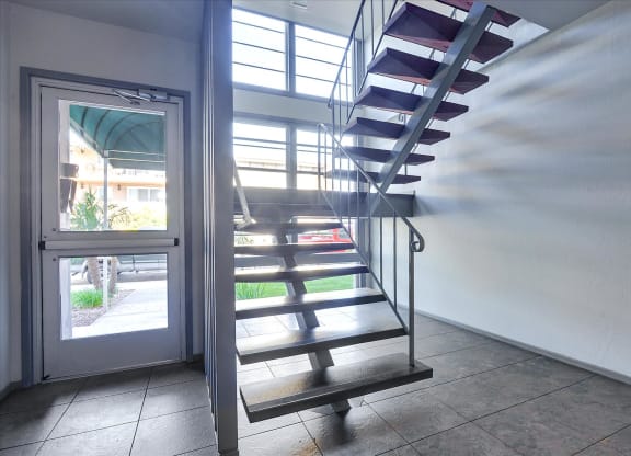a spiral staircase in a home with a glass door