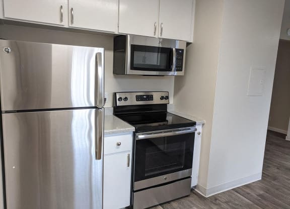 a kitchen with stainless steel appliances and a refrigerator
