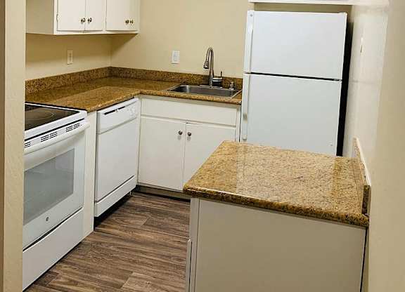 a kitchen with white appliances and a counter top