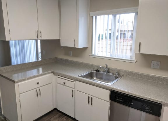 a kitchen with white cabinets and a sink