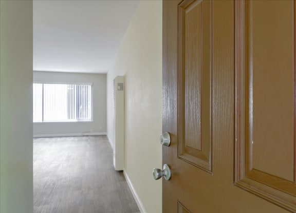a door opening into a room with a view of a living room