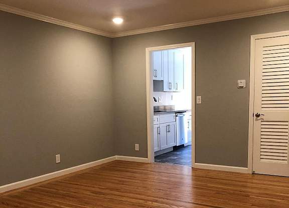 A room with wooden floors and a white door.