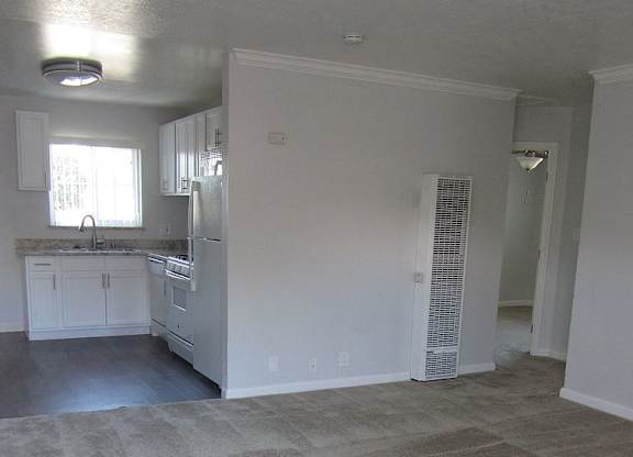 A kitchen with white cabinets and appliances is shown.