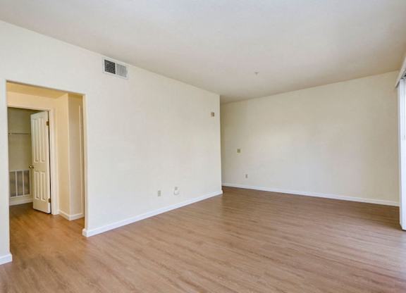 A room with wooden floors and white walls.