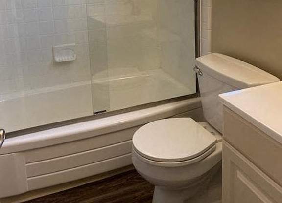 a bathroom with a toilet and a shower