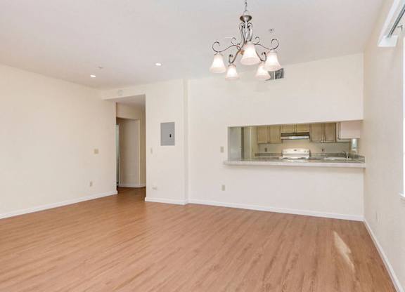 A room with wooden floors and a chandelier.