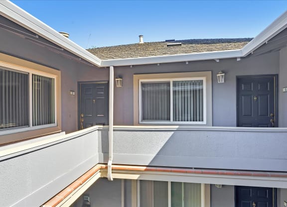A balcony of a house with a view of the sky.