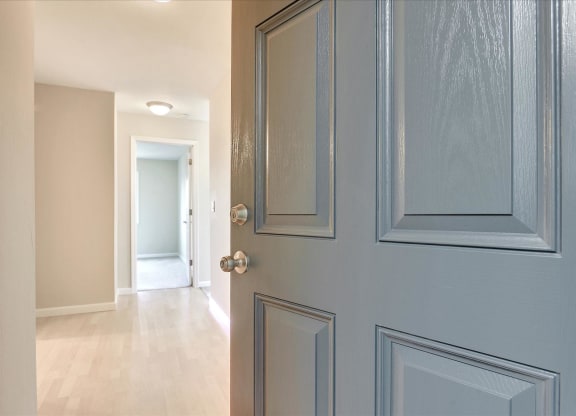 the door to the hallway of a home with a hallway door open and a hallway