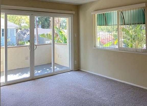 an empty living room with a sliding glass door