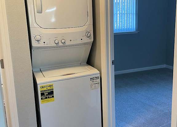 A white oven and microwave are in a kitchen.