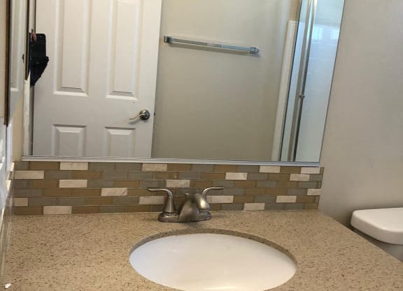a bathroom with a sink and a mirror