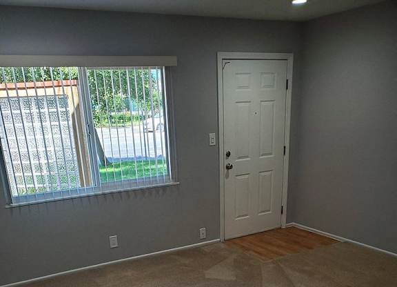A room with a door and a window.