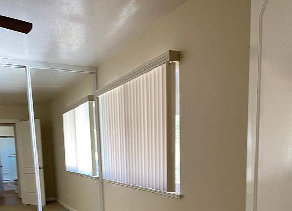 the walls of a room with many windows and a door