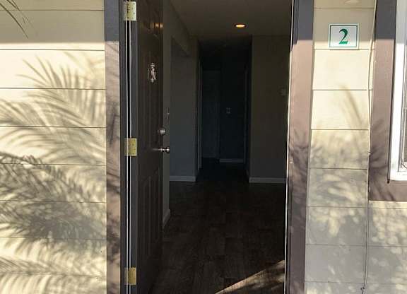 A door with a glass window and a sign above it that says 2.