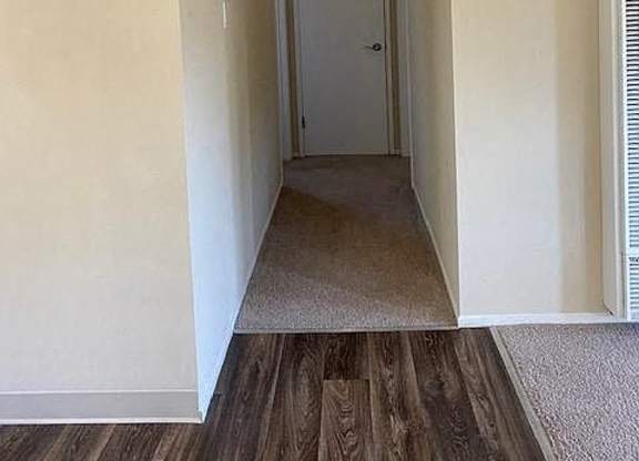a hallway with a door and a light on the ceiling