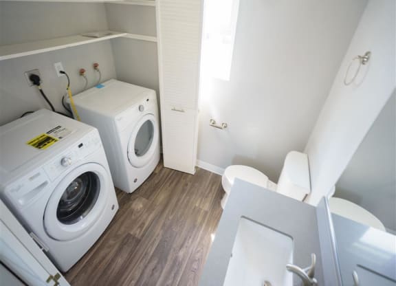 a bathroom with a washing machine and a toilet