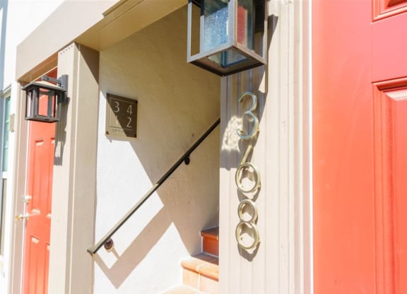the front door of a house with a light and numbers on it