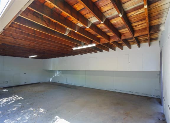 a empty room with wooden ceilings and white walls